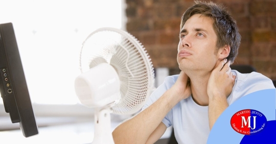 man in front of fan