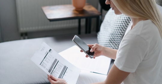 woman looking at utility bill